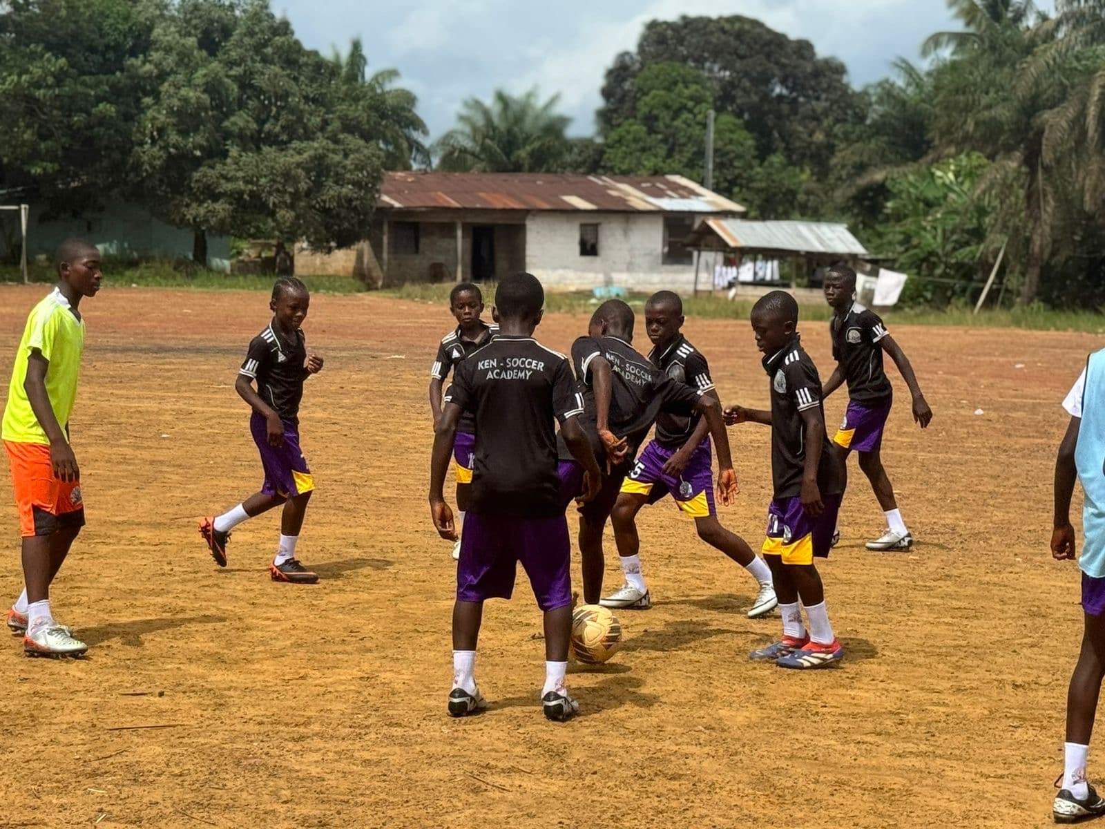Young Ken Soccer Academy players practicing together on a football field